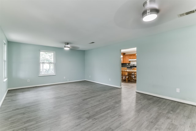 unfurnished room with ceiling fan and hardwood / wood-style flooring