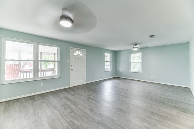 interior space with wood-type flooring and ceiling fan