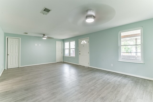 empty room with wood-type flooring and ceiling fan