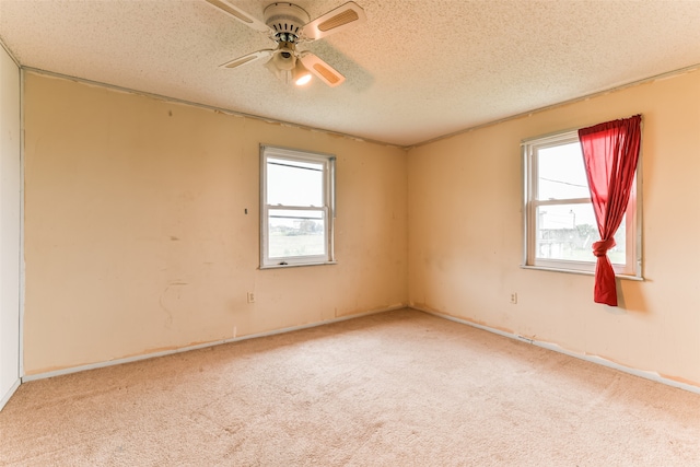 unfurnished room featuring ceiling fan, a textured ceiling, and carpet flooring