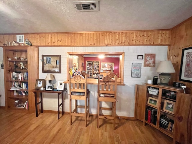 dining room featuring hardwood / wood-style flooring and a textured ceiling