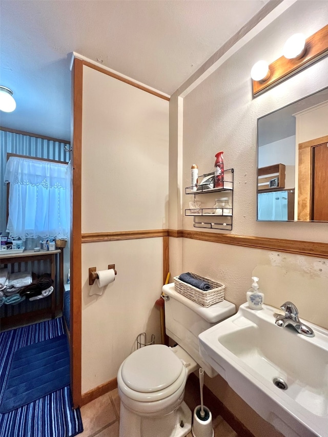 bathroom with sink, tile patterned flooring, and toilet