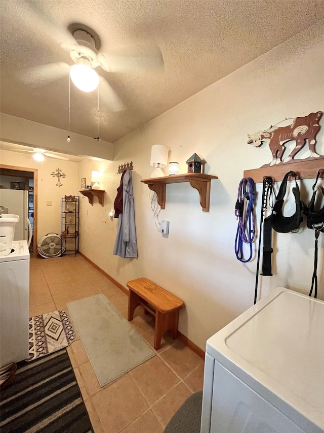 laundry room with washer / dryer, tile patterned flooring, ceiling fan, and a textured ceiling