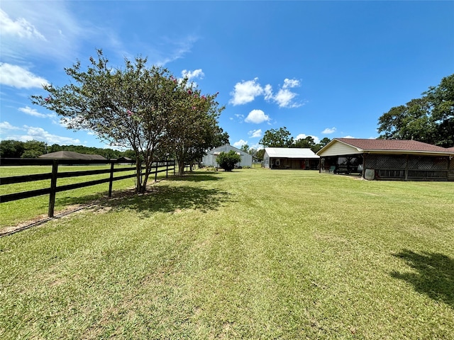 view of yard with a rural view