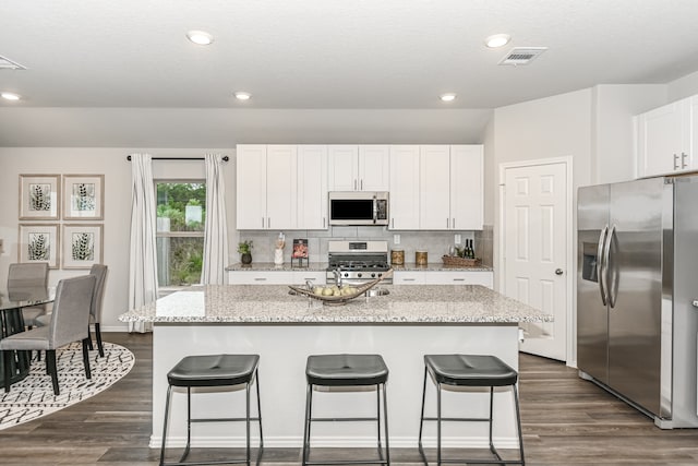 kitchen featuring a center island, dark hardwood / wood-style floors, and stainless steel appliances