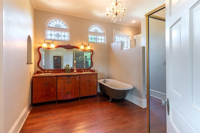 bathroom featuring crown molding, an inviting chandelier, a wealth of natural light, and hardwood / wood-style flooring