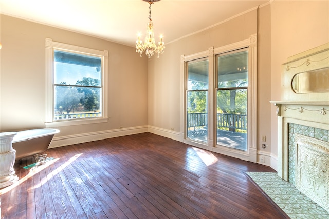 interior space featuring an inviting chandelier, crown molding, and dark hardwood / wood-style flooring