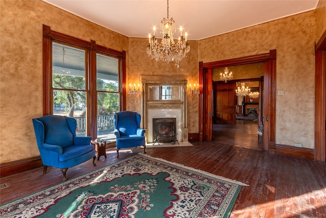 living area with a notable chandelier and dark hardwood / wood-style floors