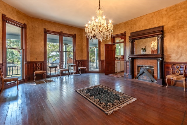 unfurnished room with a notable chandelier and dark hardwood / wood-style flooring