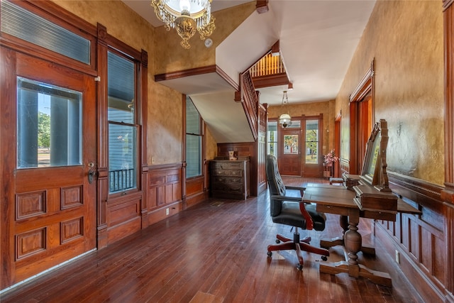 office with a healthy amount of sunlight, dark hardwood / wood-style flooring, and an inviting chandelier