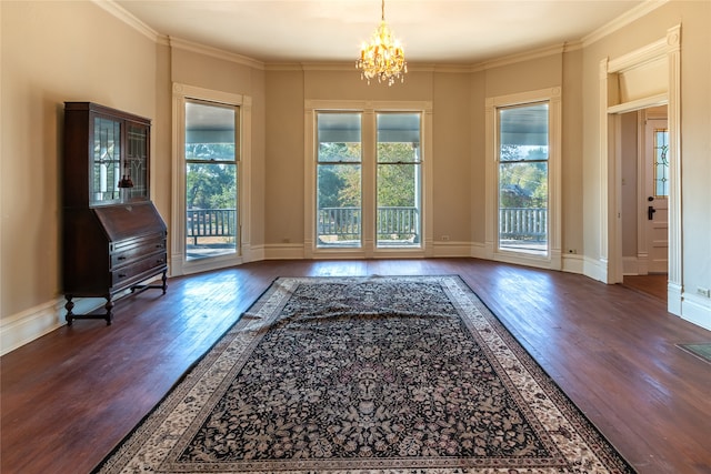 doorway featuring a chandelier, dark wood-type flooring, and ornamental molding