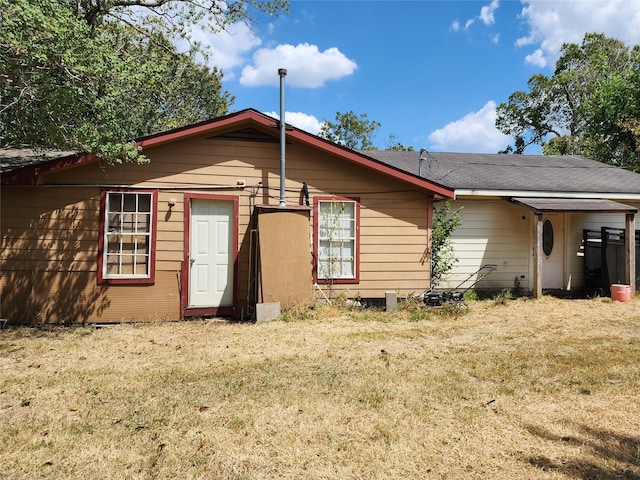 rear view of house featuring a yard