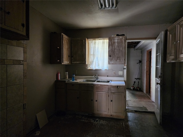 kitchen with sink and dark tile floors