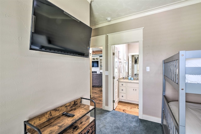 interior space with sink, carpet floors, and ornamental molding