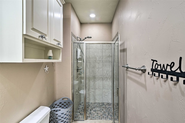 bathroom with walk in shower and toilet