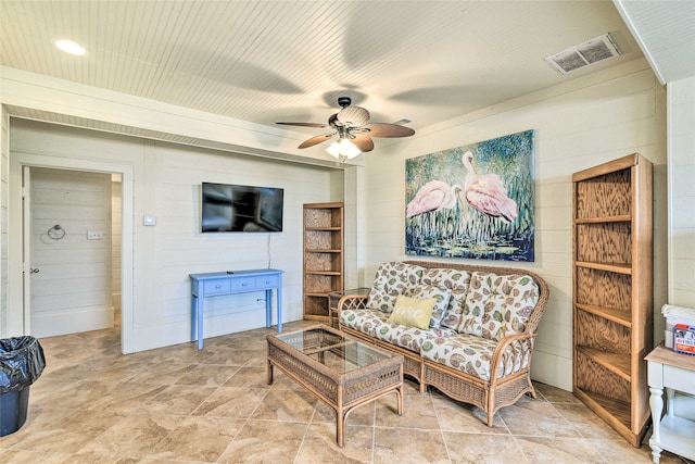 living room with light tile flooring and ceiling fan