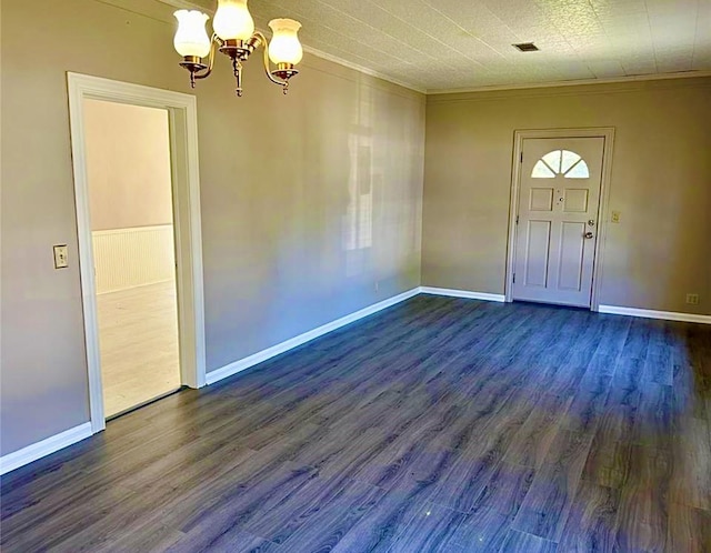 911 Dallas St, Port Neches, TX 77651 - entryway with dark wood-style flooring, a notable chandelier, crown molding, and baseboards
