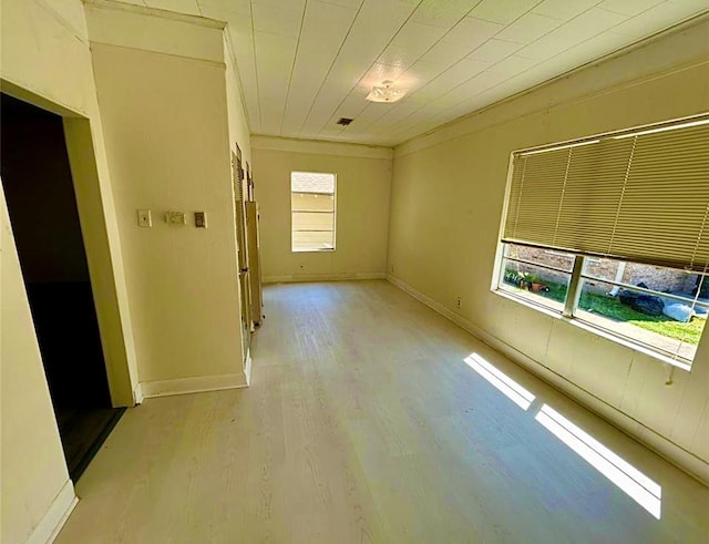 911 Dallas St, Port Neches, TX 77651 - unfurnished room with baseboards, crown molding, and light wood-type flooring