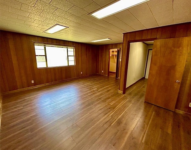 911 Dallas St, Port Neches, TX 77651 - empty room featuring baseboards, wood finished floors, and wooden walls