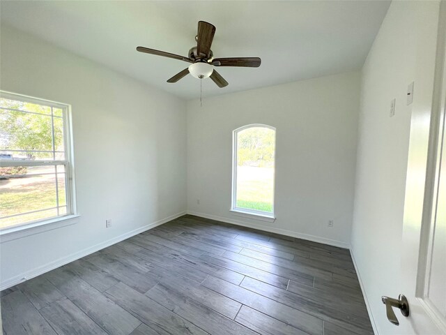 unfurnished room featuring ceiling fan and dark hardwood / wood-style flooring