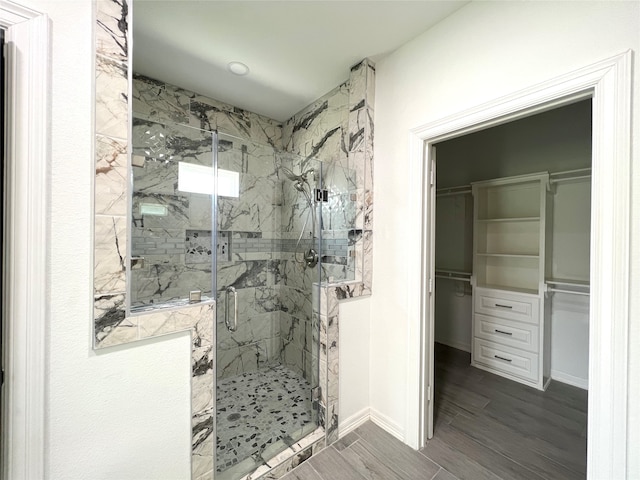 bathroom featuring walk in shower and hardwood / wood-style flooring