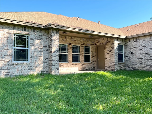 rear view of property with a yard