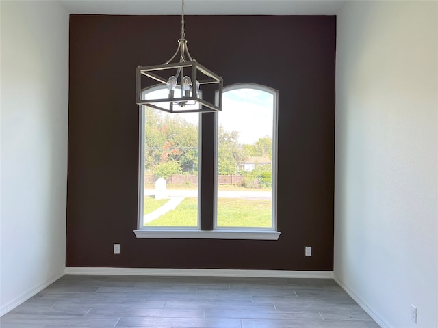 interior space with a notable chandelier and dark hardwood / wood-style flooring