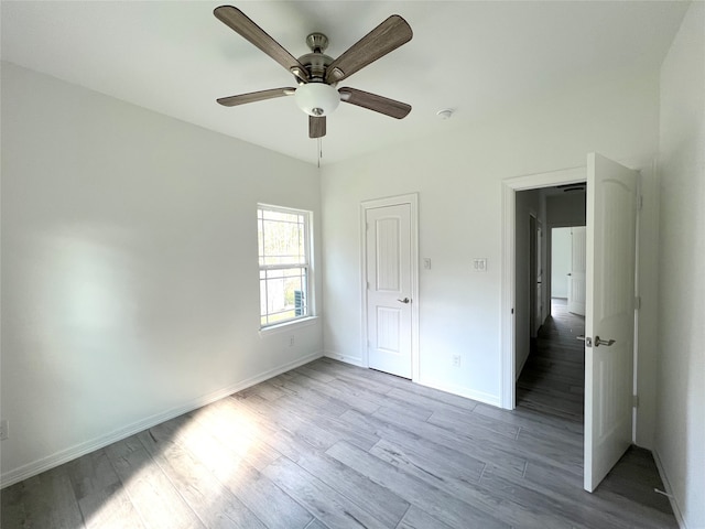 unfurnished bedroom featuring ceiling fan and light hardwood / wood-style flooring