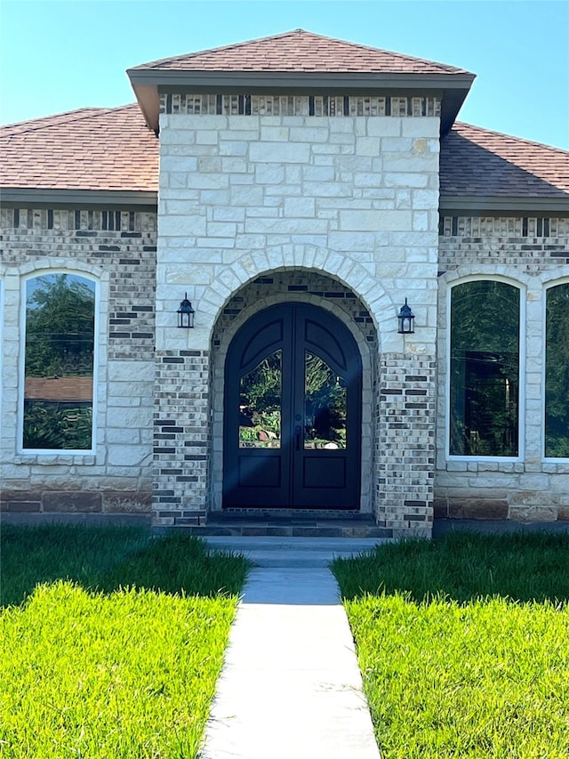 doorway to property with a yard and french doors