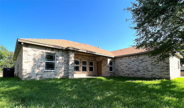 rear view of property featuring a yard