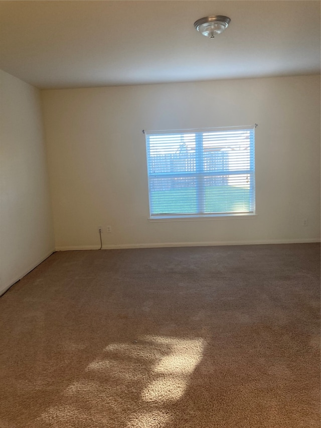 unfurnished room featuring dark colored carpet