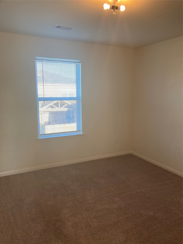 unfurnished room featuring carpet flooring and a healthy amount of sunlight