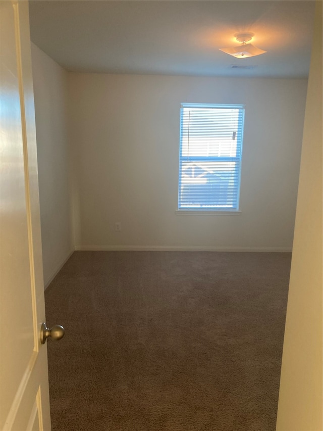 empty room with dark carpet