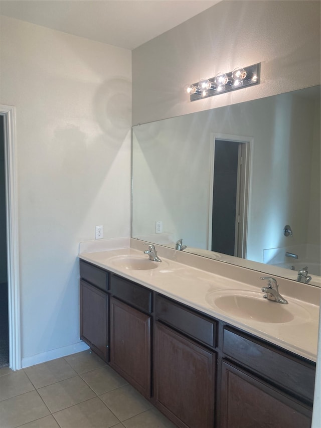 bathroom with tile flooring and double vanity