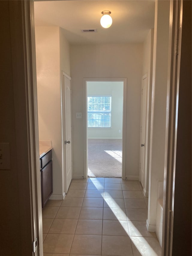 hallway with light tile floors