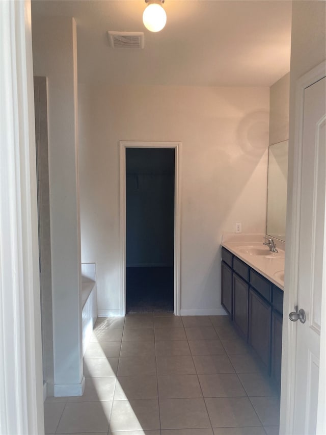 bathroom with dual bowl vanity and tile floors