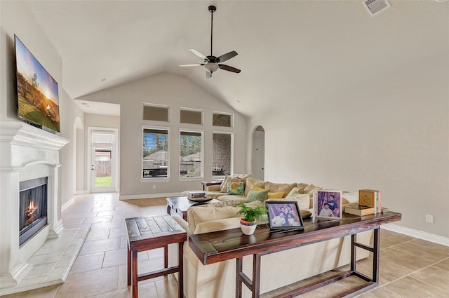 living room with ceiling fan, light tile floors, and high vaulted ceiling