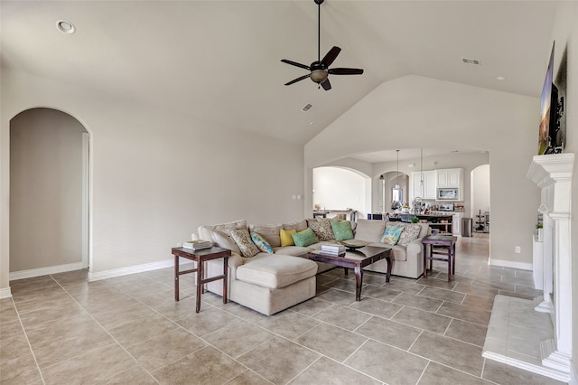 living room with light tile floors, ceiling fan, and high vaulted ceiling