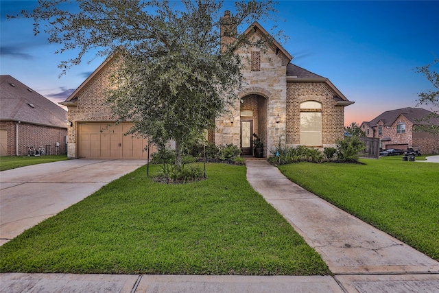 french country inspired facade with a yard