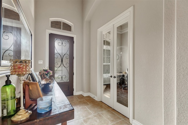 entryway with light tile floors and french doors