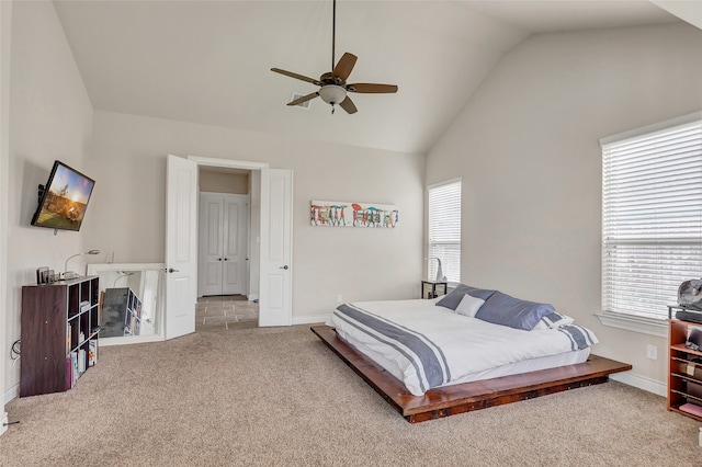 carpeted bedroom featuring multiple windows, ceiling fan, and high vaulted ceiling