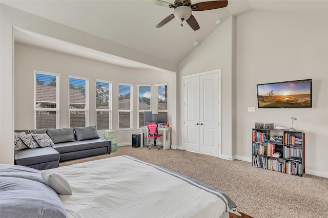 bedroom with ceiling fan, light colored carpet, high vaulted ceiling, and a closet