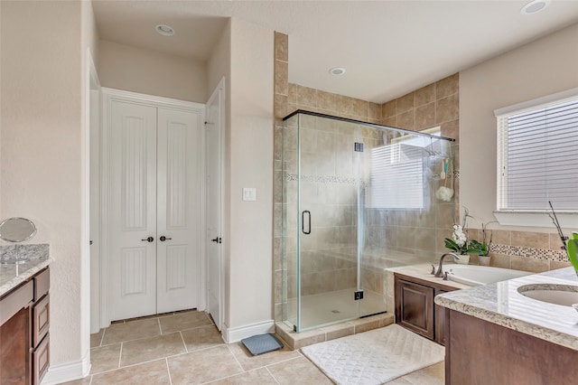 bathroom featuring shower with separate bathtub, vanity, and tile floors