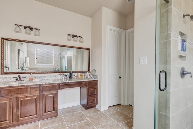 bathroom featuring tile floors, a shower with door, and dual vanity