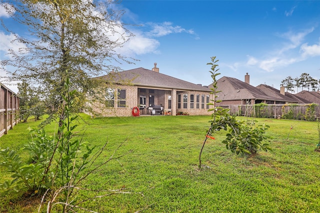 back of house featuring a yard