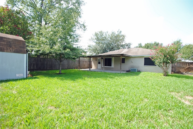 view of yard featuring a patio area, a storage unit, and central air condition unit