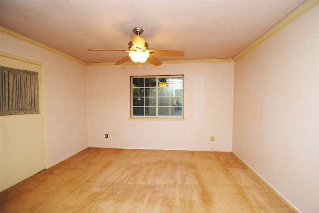 carpeted empty room with ceiling fan, a textured ceiling, and crown molding