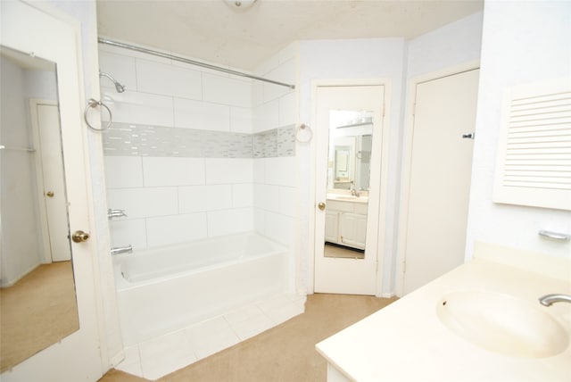 bathroom with tiled shower / bath combo and vanity