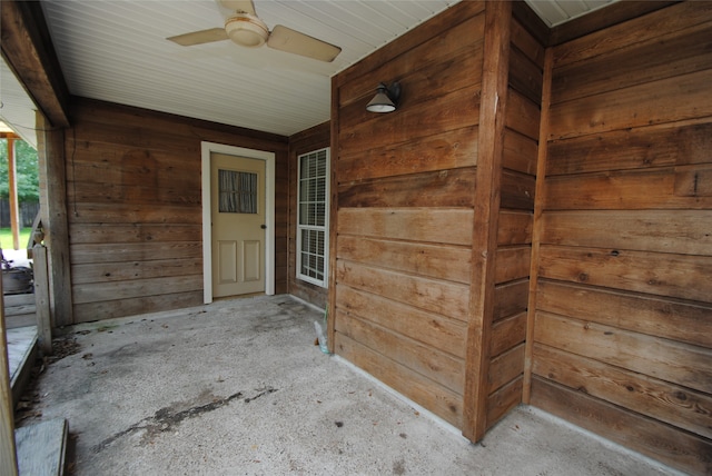 view of exterior entry with a patio area and ceiling fan