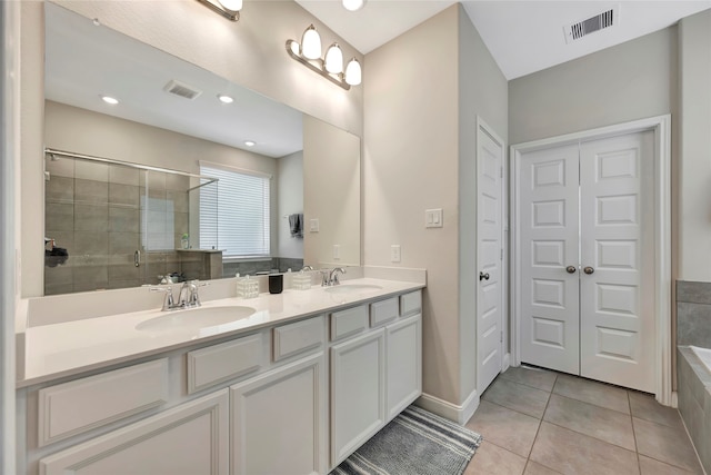 bathroom featuring vanity, tile patterned floors, and separate shower and tub